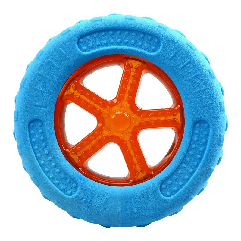 Set of three floating TPR dog toys: a red squeaky ball, a blue squeaky barbell, and an orange squeaky tire on a blue background.