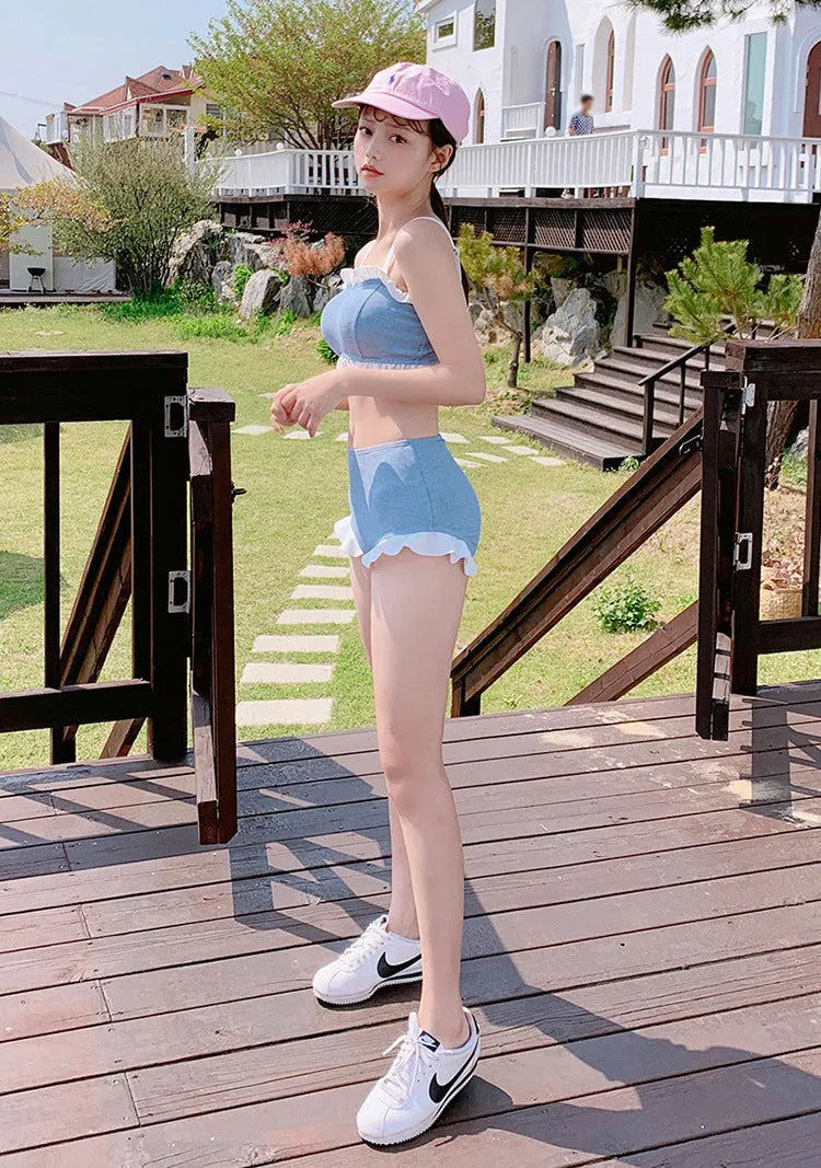 Women's solid colour one-piece swimsuit with suspender straps, designed for swimming.