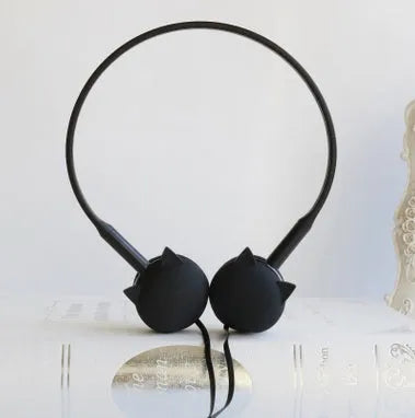 Cute black cat-shaped wired earphones with 3.5mm plug next to blue, pink, and white colour options.