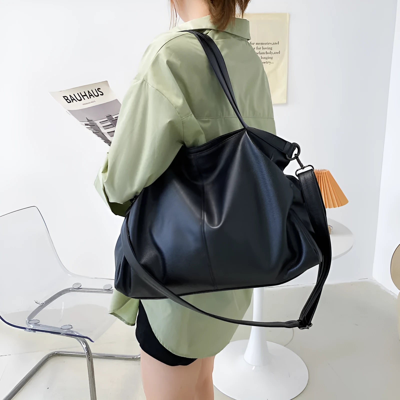 Large soft surface messenger bag in black with adjustable shoulder strap and zip opening