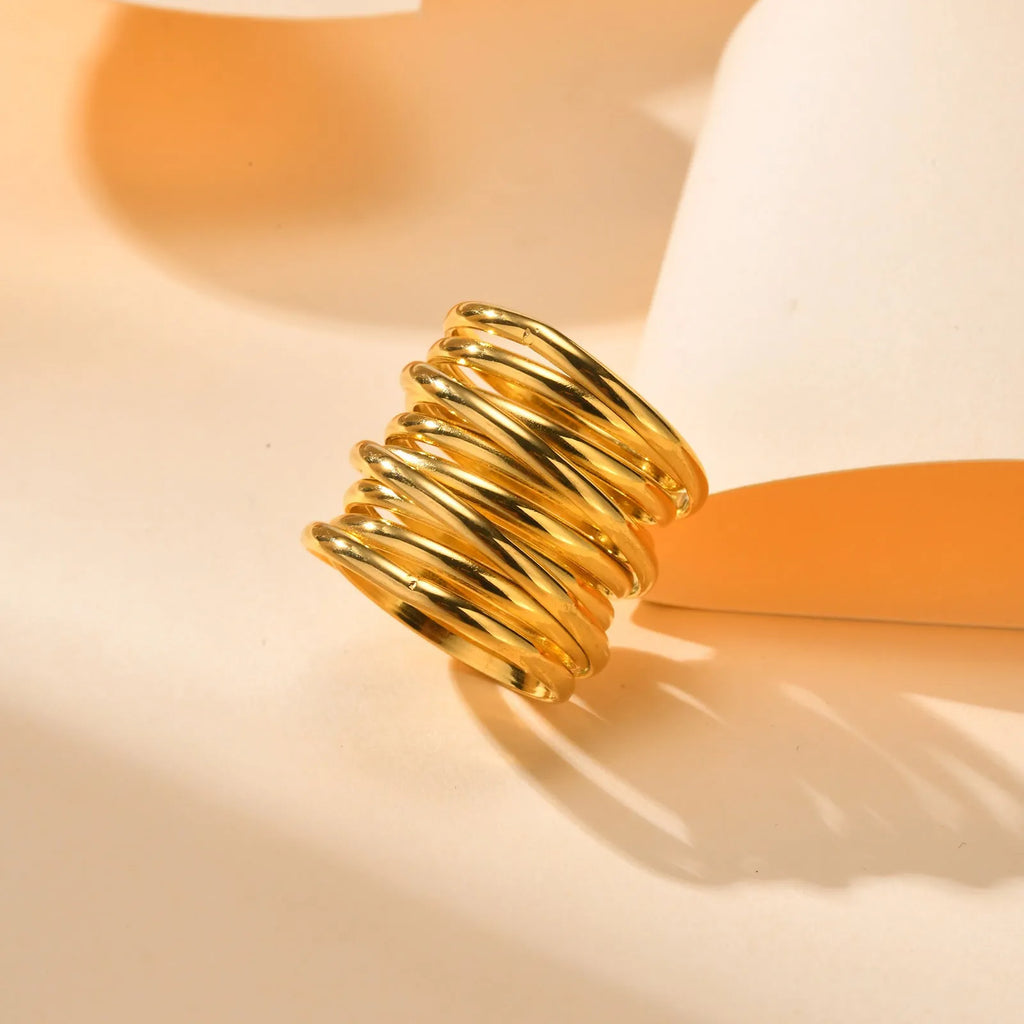 Gold electroplated stainless steel multi-loop multi-layer ring on white background in US size 7