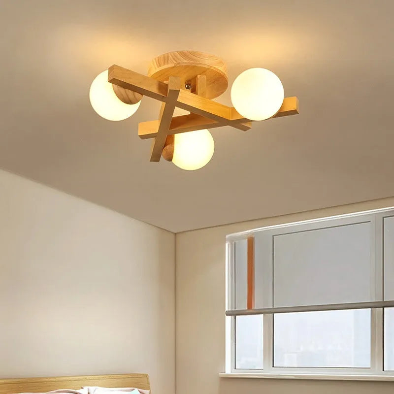 Wooden style modern Nordic ceiling light with three heads, installed in a living room.