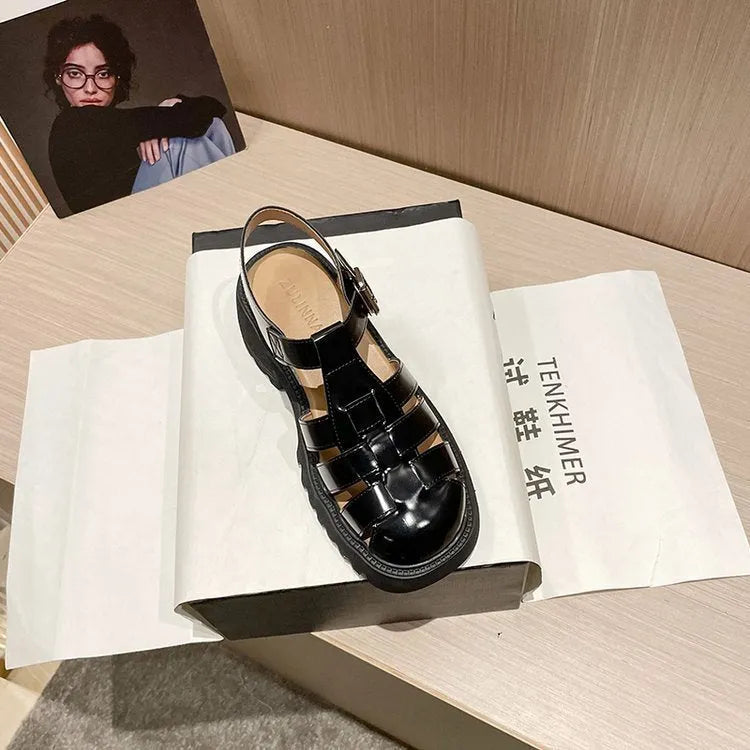 Women's black retro platform sandals with closed toe, hollow sides, chunky heel, and a buckle fastening.