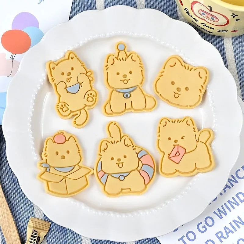 Plastic cartoon biscuit mould showing three-dimensional pet puppy designs including one with a birthday hat
