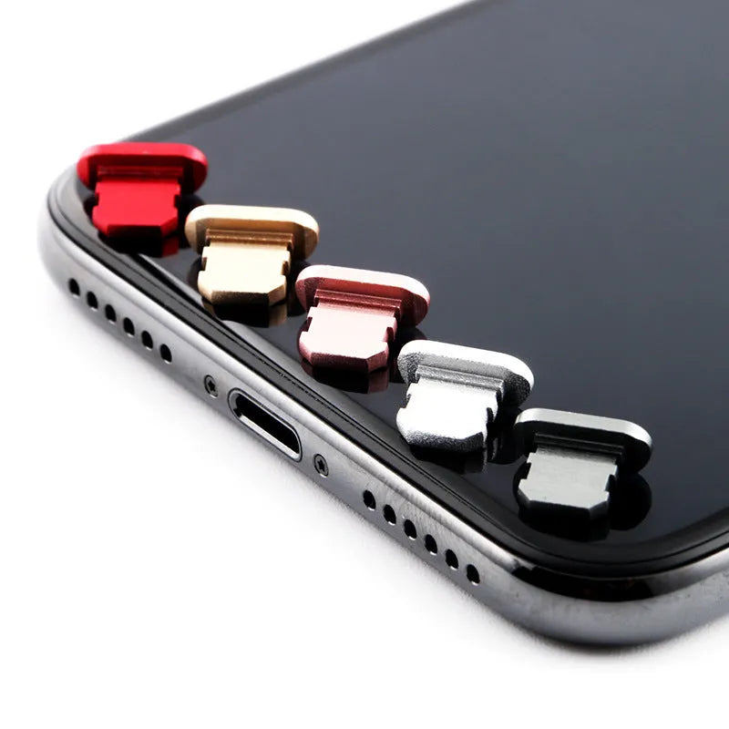 Aluminium alloy dust plug for iPhone charging port in various colours including gold and black.