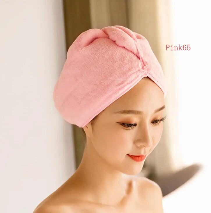 Women's microfiber hair drying cap in a light colour, showing its absorbent fabric and cap shape.