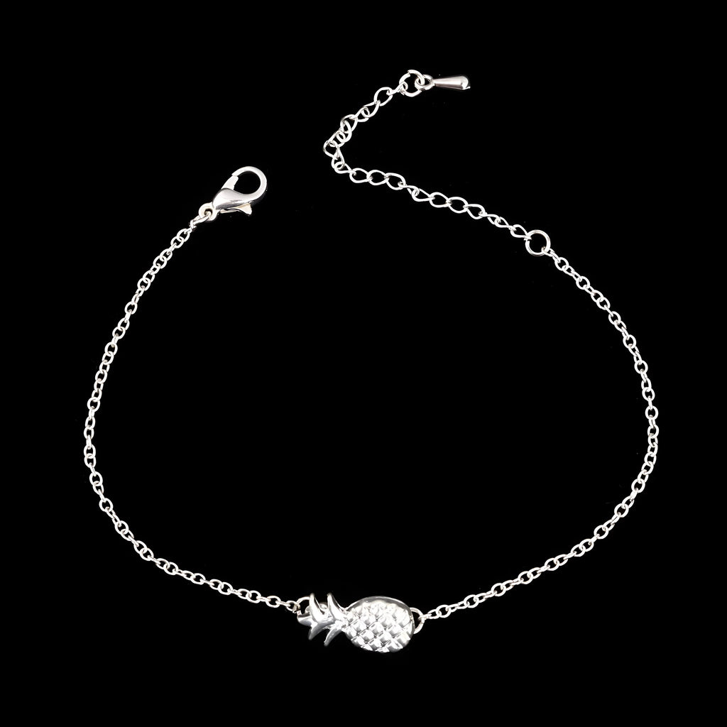 Gold or silver tone alloy bracelet with a central pineapple charm on a model's wrist.