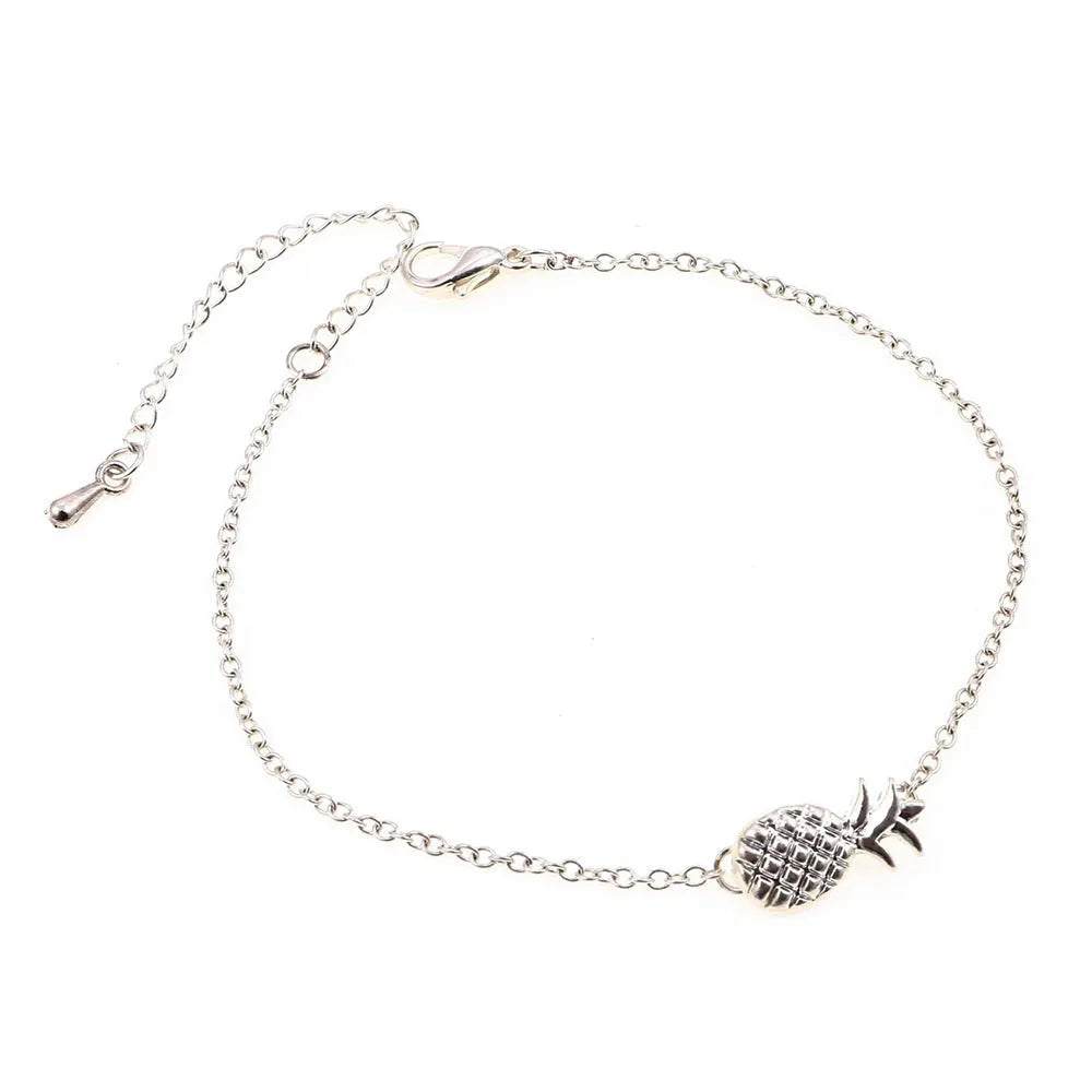 Gold or silver tone alloy bracelet with a central pineapple charm on a model's wrist.
