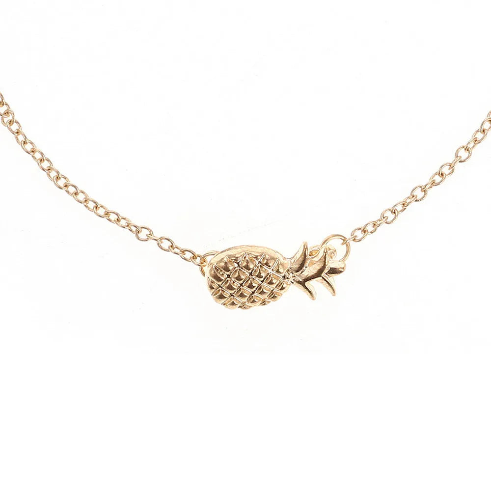 Gold or silver tone alloy bracelet with a central pineapple charm on a model's wrist.