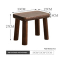 Solid wood distressed finish shoe changing stool on a wooden floor