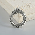 Large antique silver dragon-shaped earrings with hollow-out geometric design.