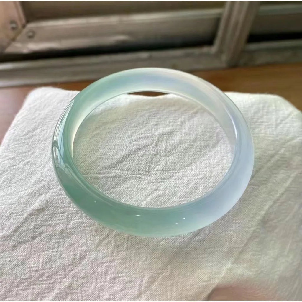 Natural agate wide tyre bracelet in a selection of colours including pink, blue, and green on a size chart showing 52mm to 62mm.