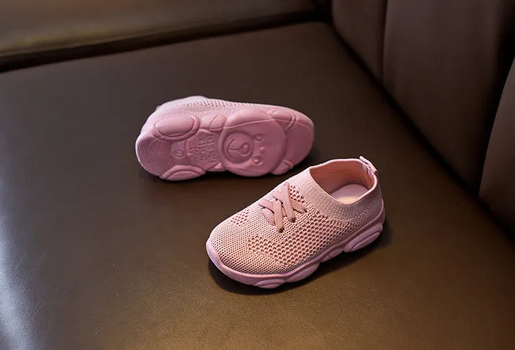Children's white lazy slip-on shoe with fabric upper and textured non-slip rubber sole.