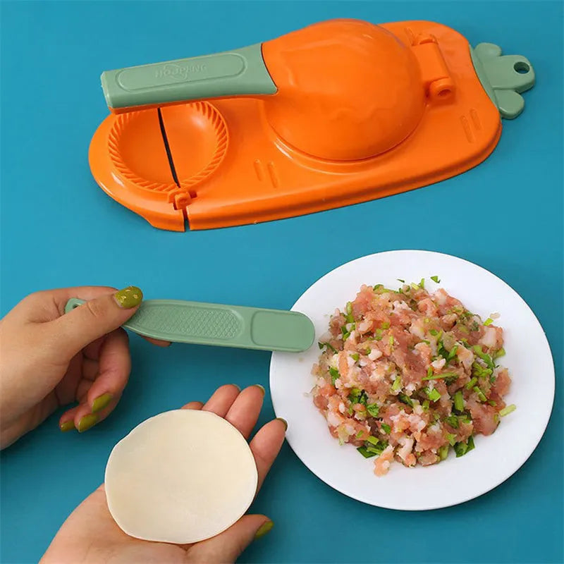 Orange and white manual kitchen dumpling press tool with ergonomic handle on wooden table