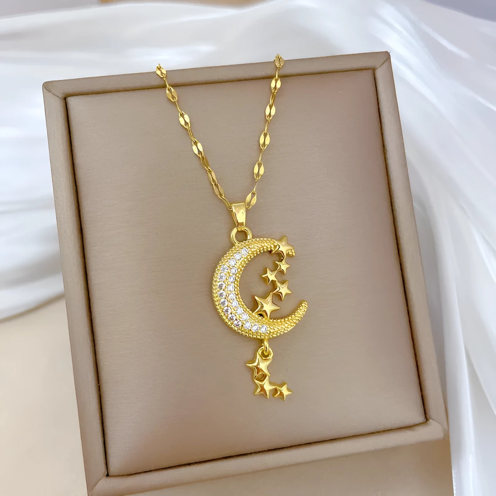 Stainless steel necklace with a copper moon pendant featuring a full diamond pattern design.