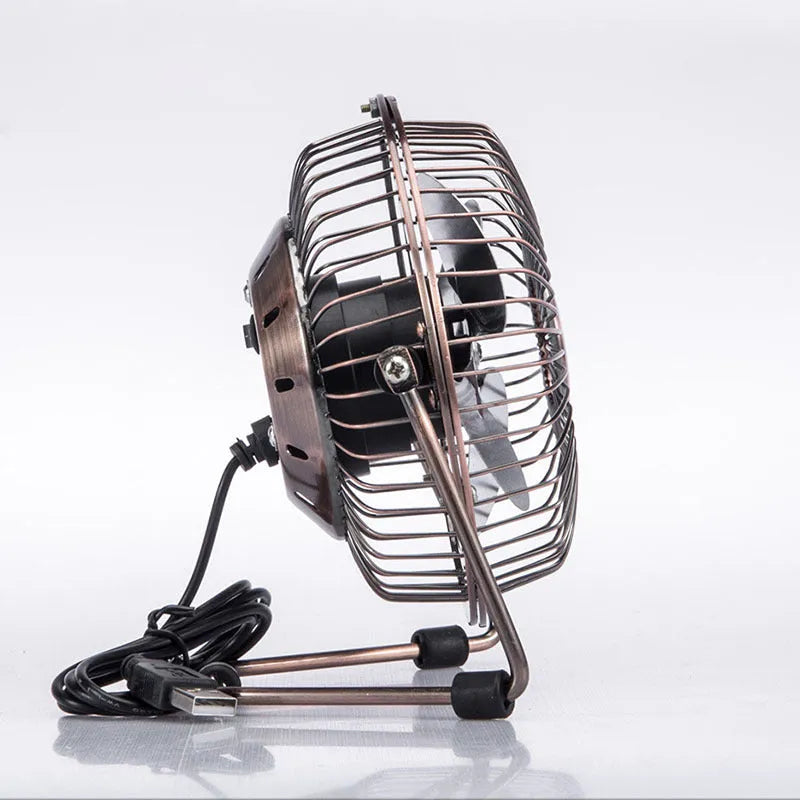 4-inch bronze aluminium USB mini fan with rocker switch on a desk