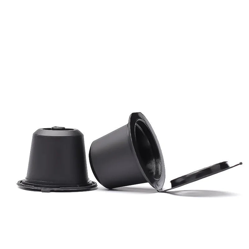 Six recyclable coffee shell filter cups in black, brown, and red plastic with a spoon