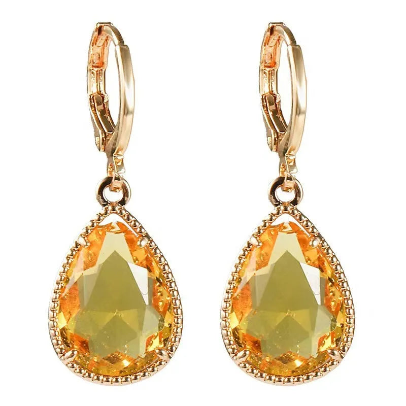 Geometric water drop earrings with carved Saturn design on rare earth glass stone in multiple colour options.