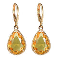 Geometric water drop earrings with carved Saturn design on rare earth glass stone in multiple colour options.