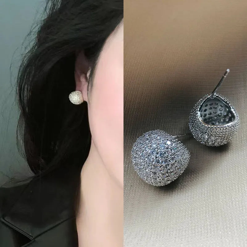 Geometric drop earrings with full diamond pave on golden spherical components in gold and white colour options