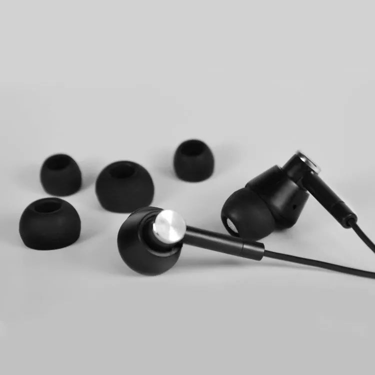 Black and white in-ear earphones with a subwoofer for computer and mobile phone use.