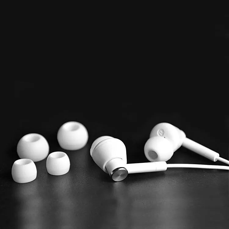 Black and white in-ear earphones with a subwoofer for computer and mobile phone use.