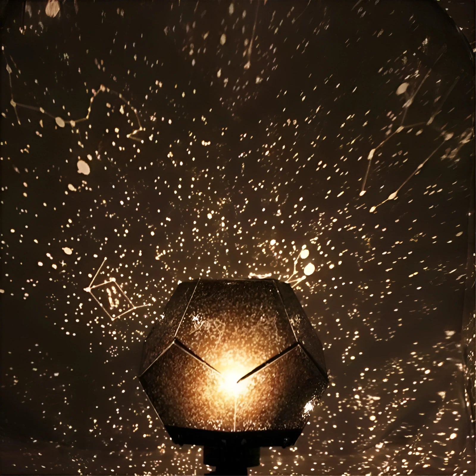 Plastic LED star projector lamp projecting blue constellations on a wall.