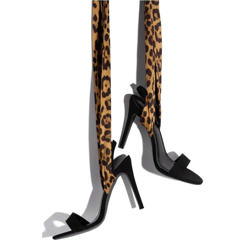 Light brown women's high-heeled sandals with leopard print and Roman cross straps on a fine high heel.