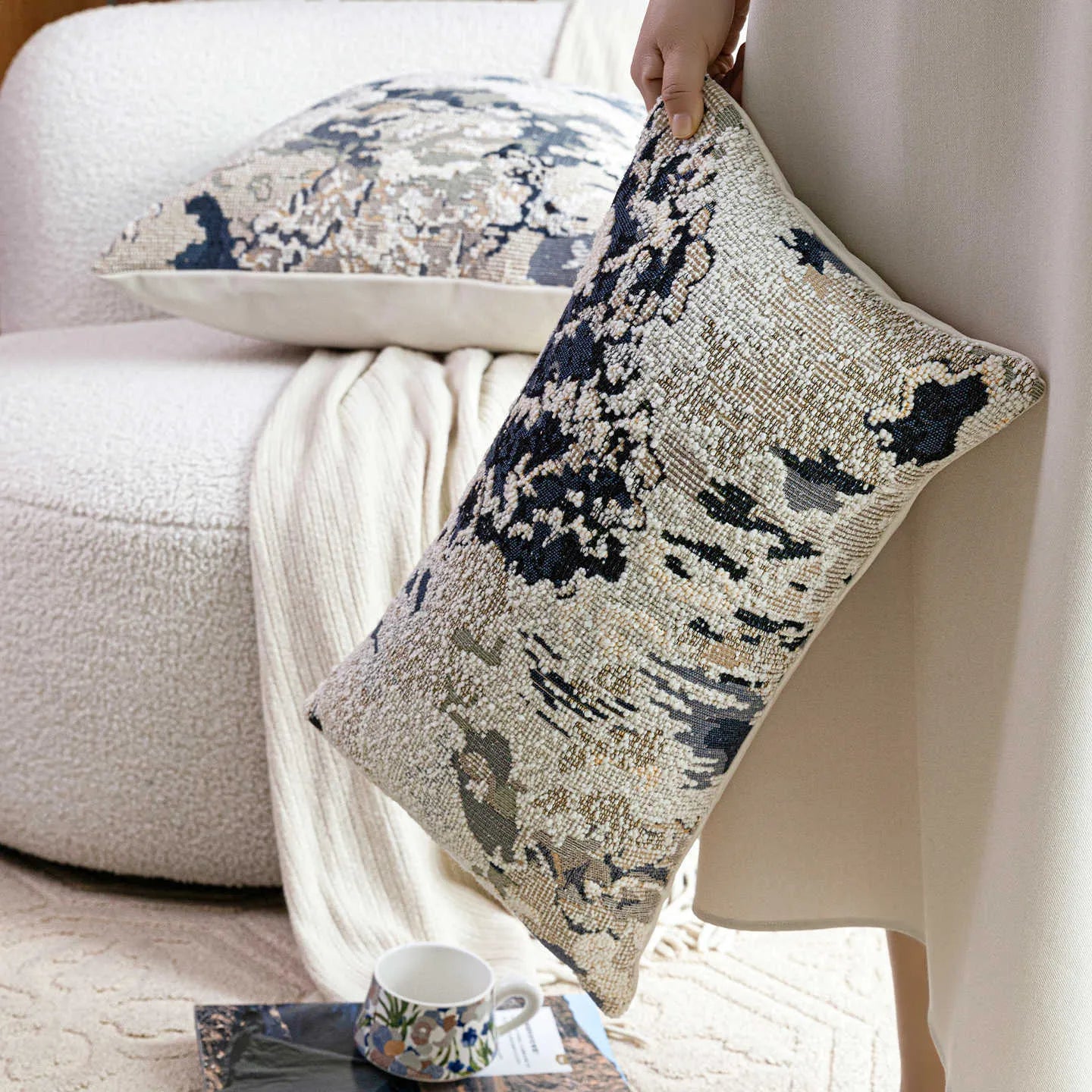 Antique blue floral patterned pillow on a sofa, shown in square and rectangular waist pillow sizes.
