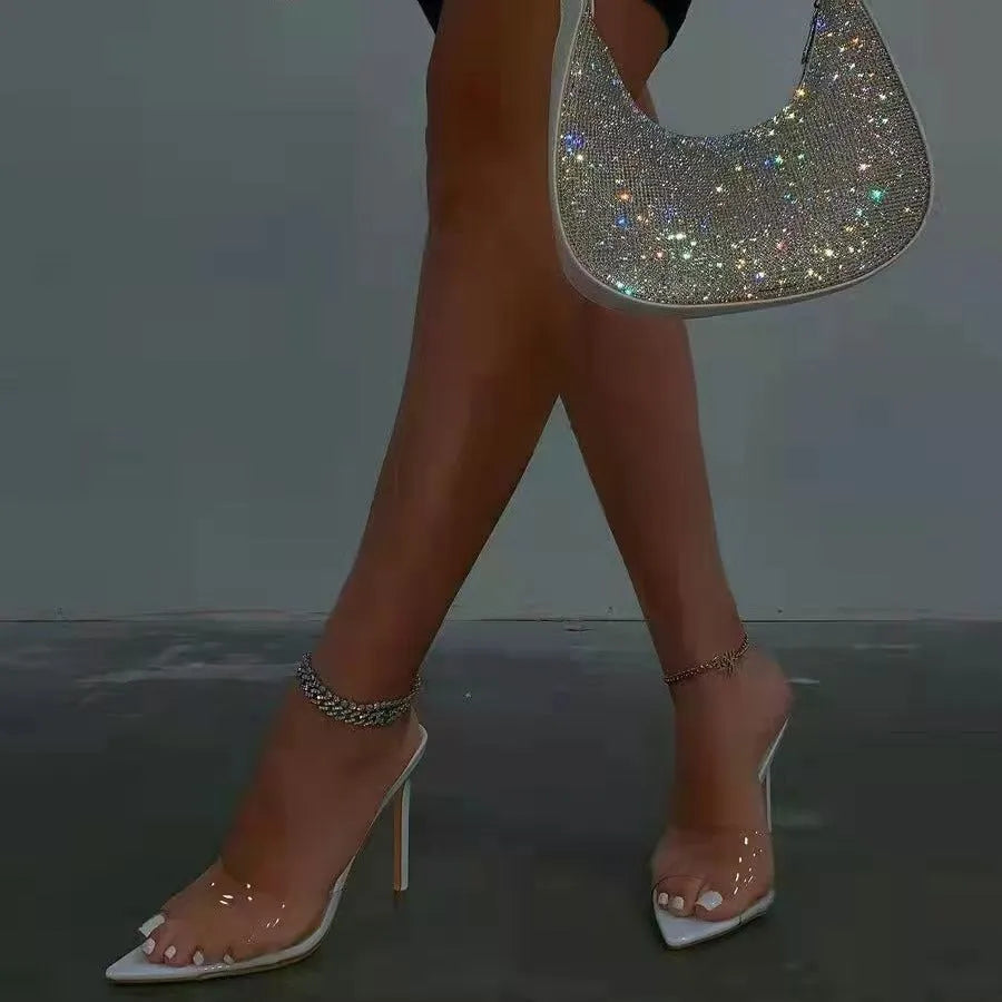 Women's black ultra-high vamp stiletto heel slippers with pointed toe on a rubber sole.