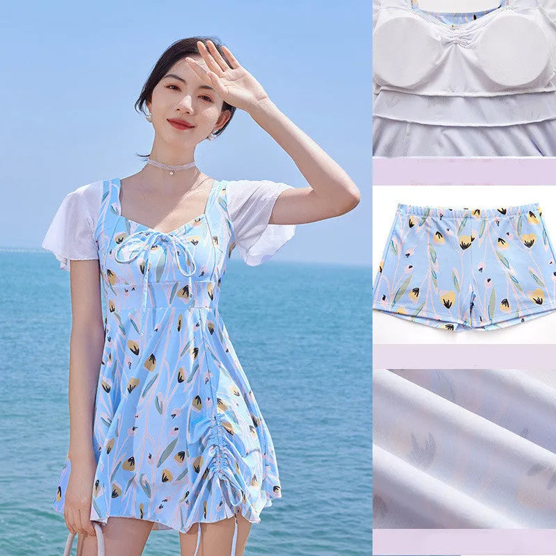 Women's sea salt blue floral one-piece polyester swimsuit on a hanger.
