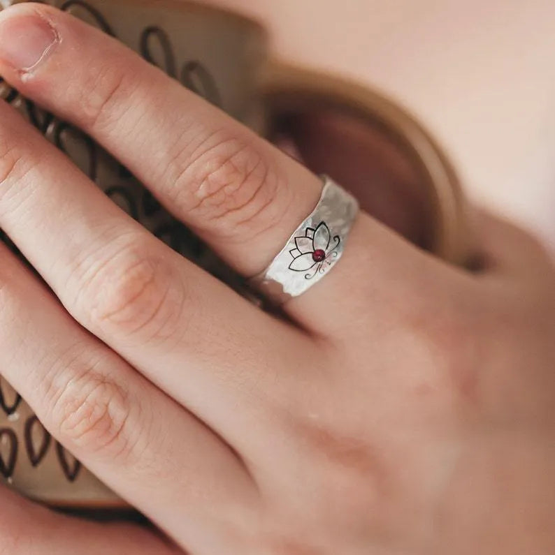 Silver alloy electroplated lotus ring on a light background, glossy finish, minimalist design