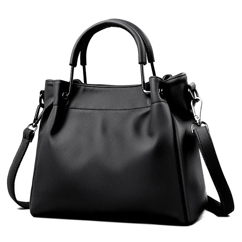 Soft PU leather bucket bag in black with visible sewing thread and external slit pocket