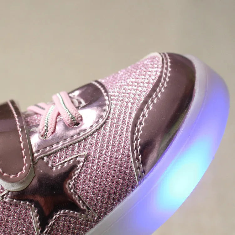 Children's LED light-up trainers with glowing rainbow soles in golden, pink and silvery colours