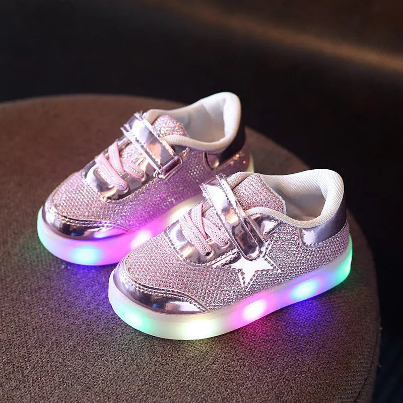 Children's LED light-up trainers with glowing rainbow soles in golden, pink and silvery colours
