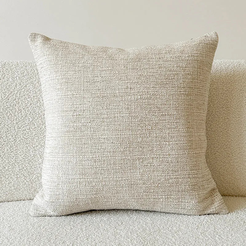 American-style jacquard woven throw pillow cover with a paisley pattern in amber colours on a sofa.