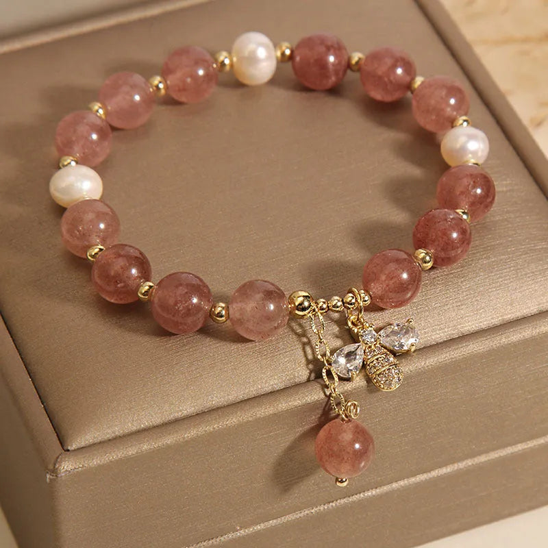 Women's bracelet with strawberry quartz beads, freshwater pearls, and zircon accents on an alloy setting.