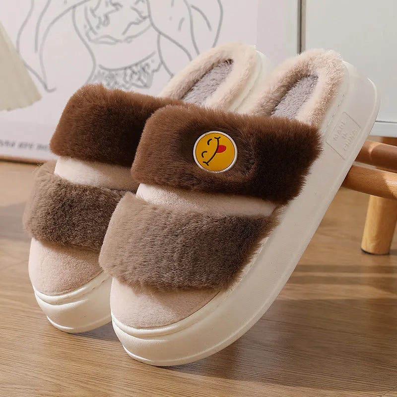 A pair of pink and green thermal cotton overshoe slippers with plush exterior and cashmere lining.