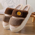 A pair of pink and green thermal cotton overshoe slippers with plush exterior and cashmere lining.