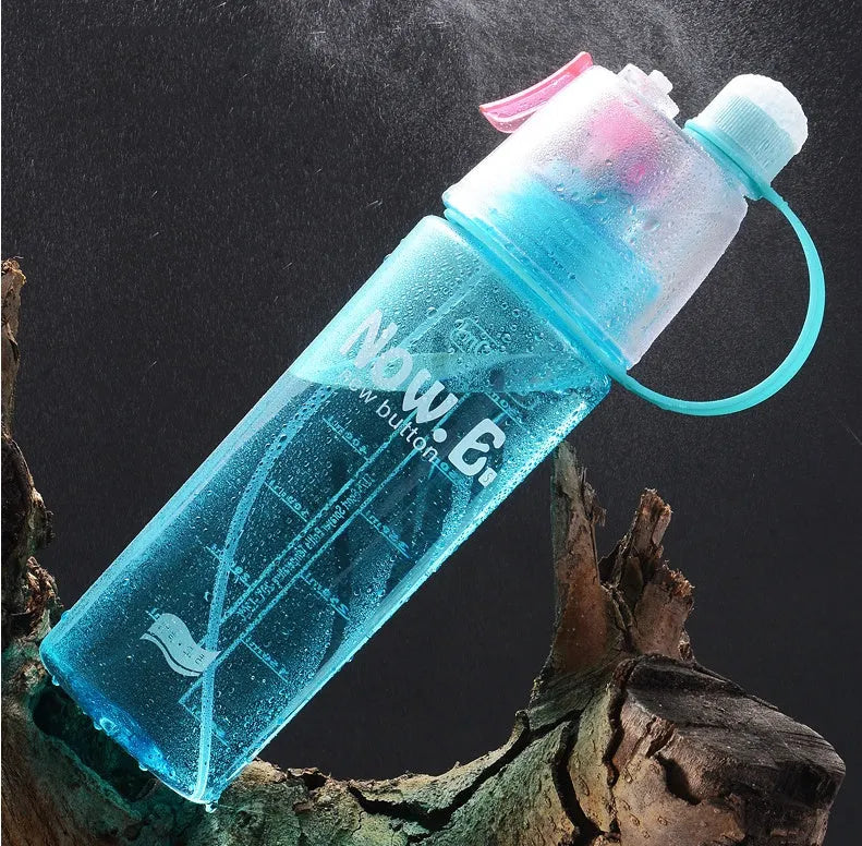 Green portable sports mist spray cup with handle, spray nozzle, and visible water level scale.