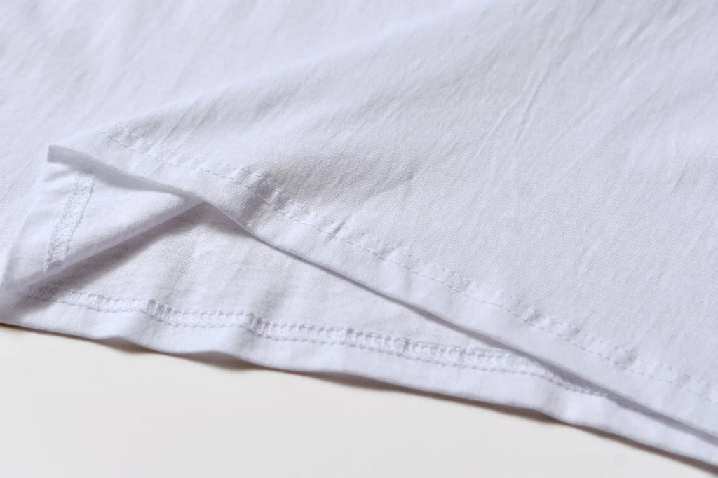 White cotton denim overalls with round neck and short sleeves, loose fit pullover style