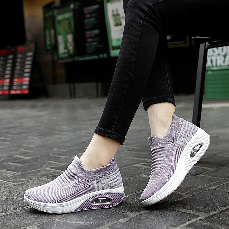Women's platform slip-on rocking shoes in black, side view, Flyknit upper, round toe