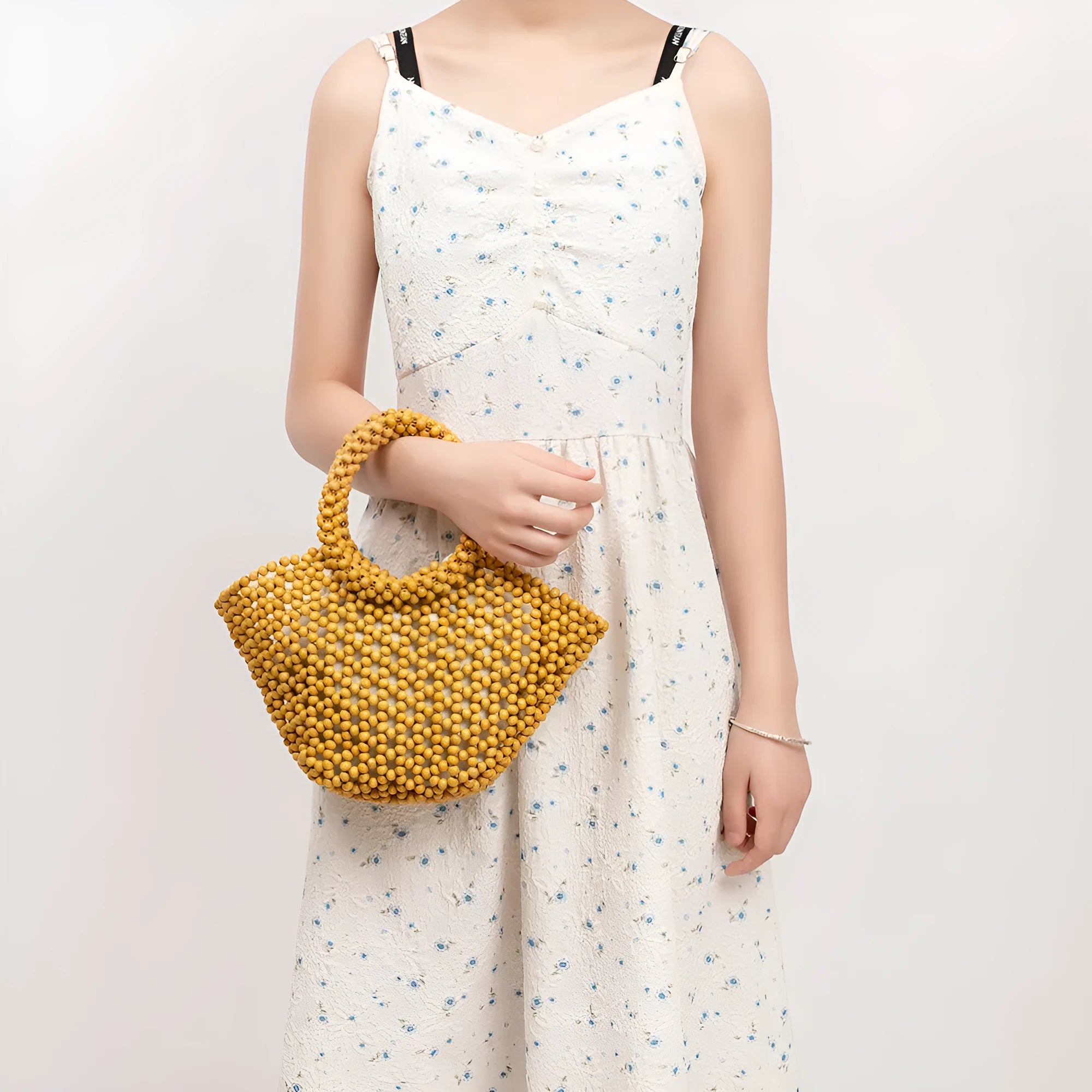 Hand-woven maple beach bag with wooden bead decoration showing hollow dumpling design