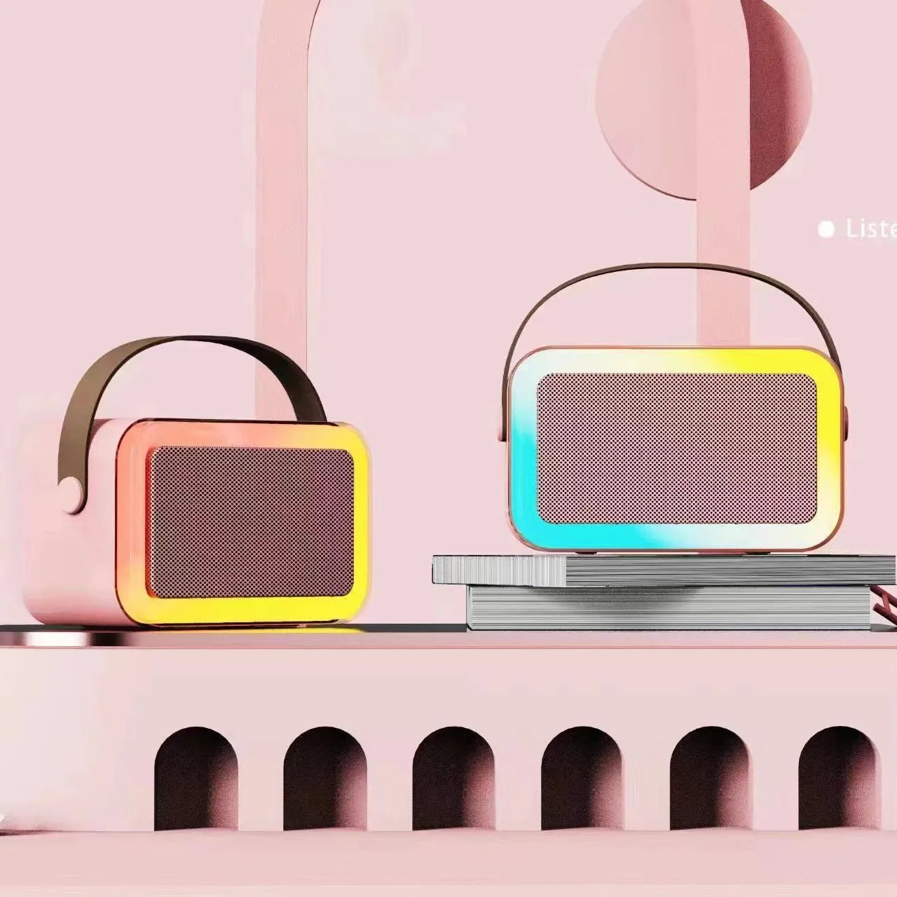 Pink portable Bluetooth speaker with microphone and coloured LED lights on a table.
