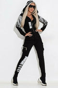 Black women's printing zip hooded casual suit with matching trousers on a hanger.