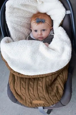 Envelope-style baby stroller sleeping bag in a plain colour, shown on a pram with lamb cashmere lining visible.