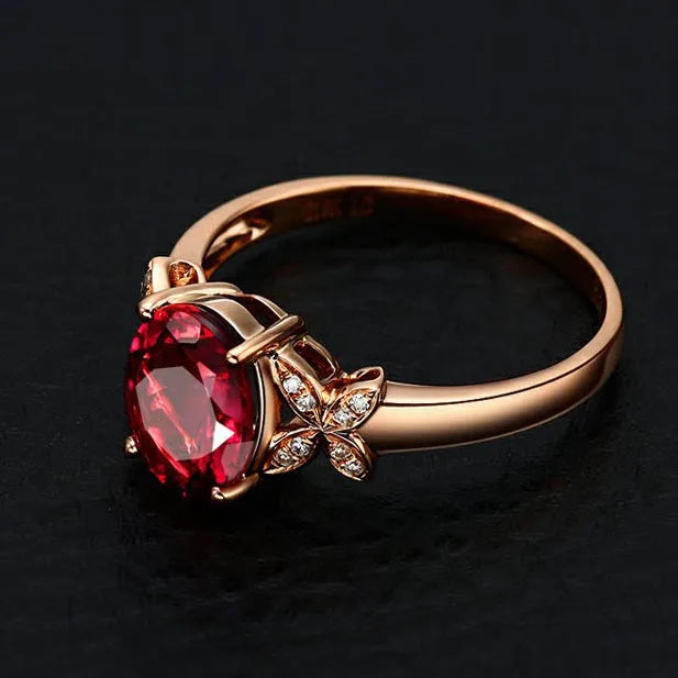 Women's copper butterfly ring with heart shape and rose gold finish showing red gemstone accent option