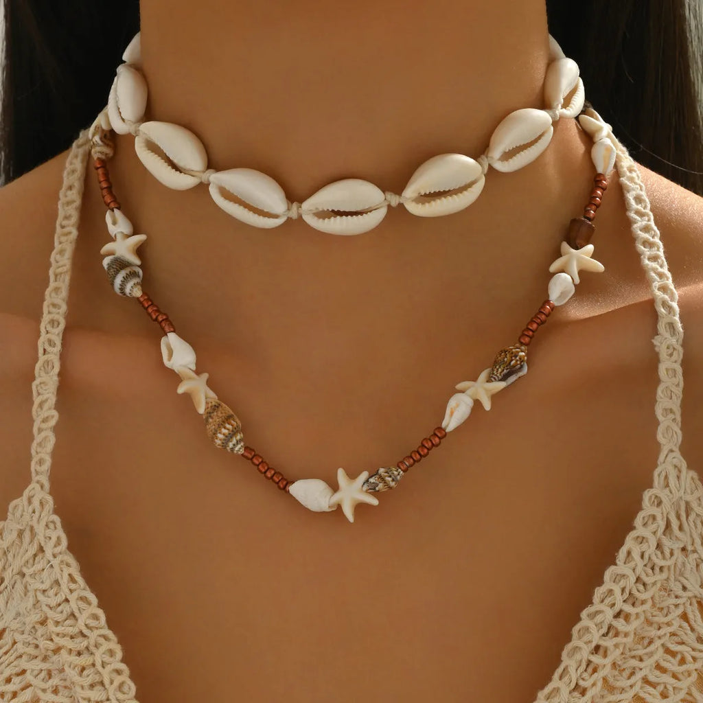 Women's bohemian shell necklace with geometric pendant on regular chain in colour X1900
