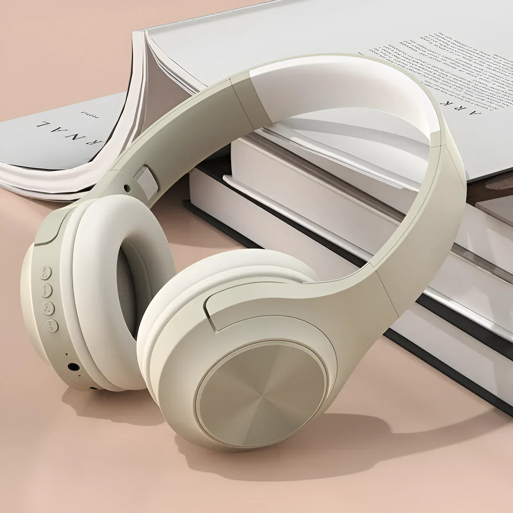 Wireless Bluetooth over-ear headphones in ivory white, chalk black, or youth green with a portable charging case.