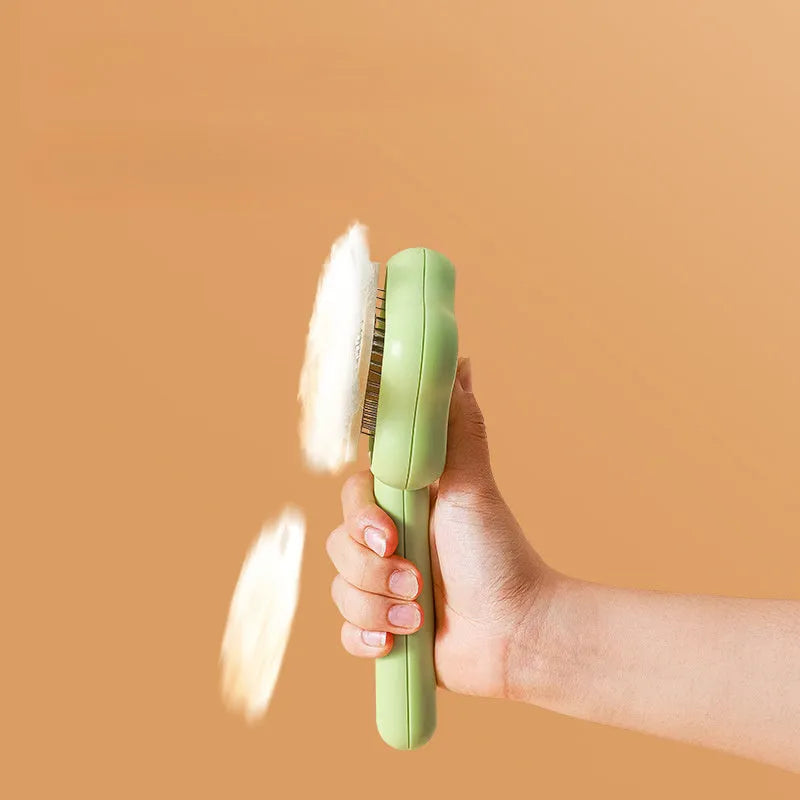 Green self-cleaning cat comb with stainless steel needle teeth and 20 cm handle